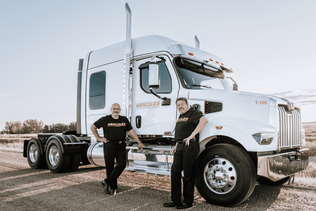Hercules President and CEO stand in front of a Hercules truck