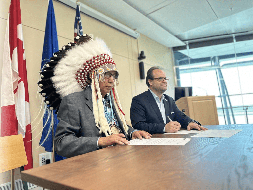 L to R: Grand Chief Leonard Standingontheroad, Montana First Nation Councilors, and Myron Keehn, CEO of Edmonton International Airport (YEG), sign the MOU between Edmonton International Airport and the Montana First Nation.