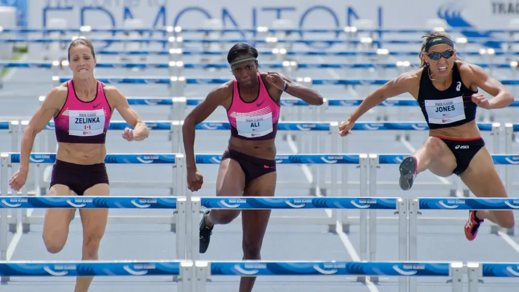 Picture of women competing for their country running hurdles - PPOC (Professional Photographers of Canada)