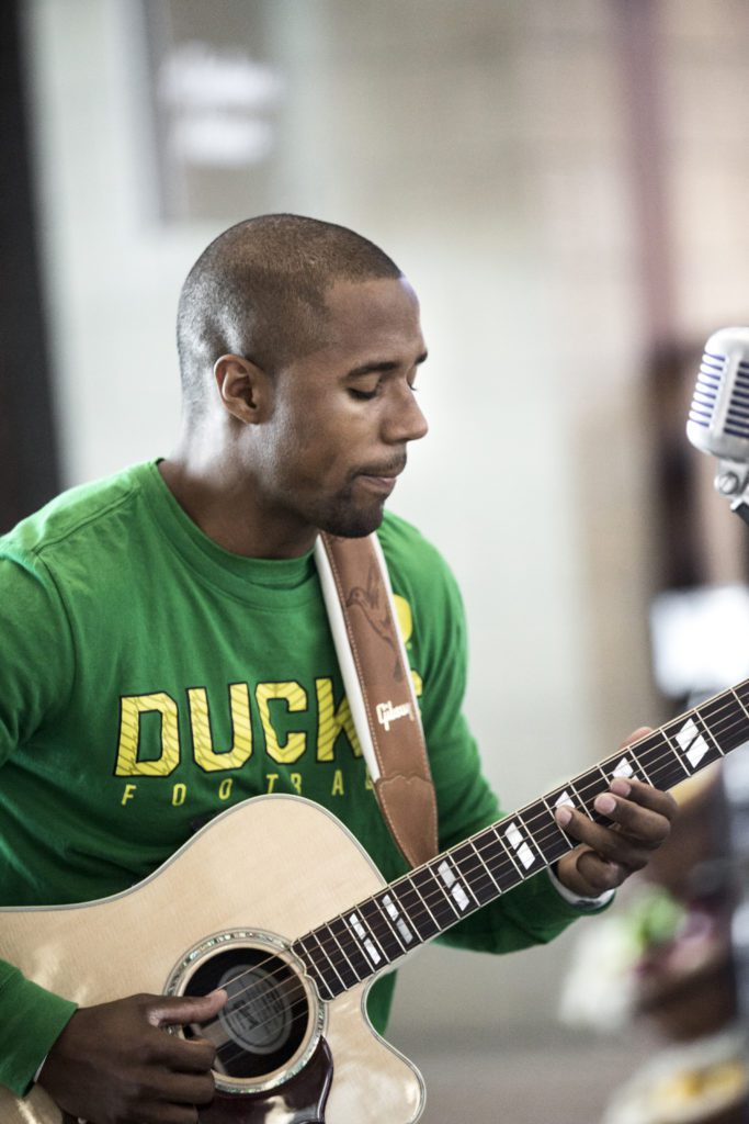 Man in green shirt playing guitar